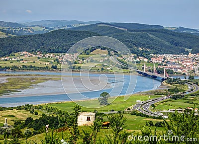 Cantabria landscape with field, river and a small town Treto. Stock Photo