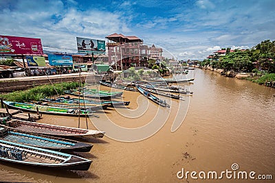 Inle Boat Station in Inle Nyaung Shwe Canal. A series of fishing boats along the river generated by Inle Lake. Homes in the backgr Editorial Stock Photo