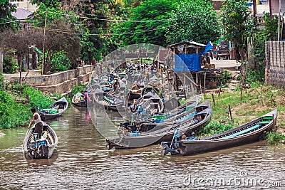 Inle Boat Station in Inle Nyaung Shwe Canal in Burma. A series of wooden fishing boats along the river generated by Inle Lake Editorial Stock Photo