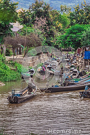 Inle Boat Station in Inle Nyaung Shwe Canal in Burma. A series of wooden fishing boats along the river generated by Inle Lake Editorial Stock Photo