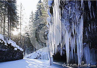 Canyon with a frozen waterfall in winter consisting of huge icicles Stock Photo