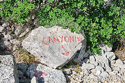 Canyoning sign on a stone, written in red, just above Cikola river, in Croatia. Adventure concept Stock Photo