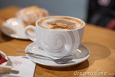 Cap of coffee with muffin/cake on the table in the cafe Stock Photo