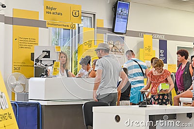 CAP D`AGDE, FRANCE - JULY 27, 2016: People stand in a queue for post office services. Sending parcel Editorial Stock Photo