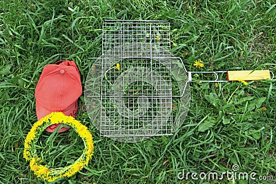 Cap and grill on green grass. picnic items Stock Photo