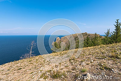 Cape Khoboy surrounded by the turquoise water of Lake Baikal is the northernmost point of Olkhon Island. Place of power in local Stock Photo