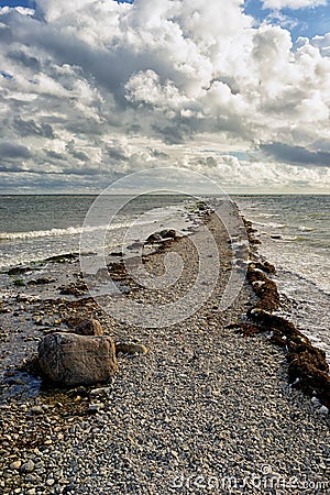 Cape of stones goes to the horizon of the sea Stock Photo