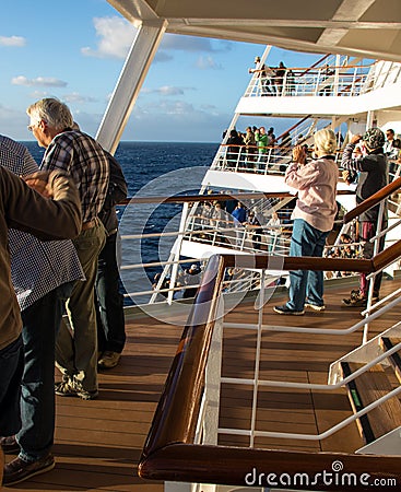 Passengers line the decks of a cruise ship on departure from port Editorial Stock Photo