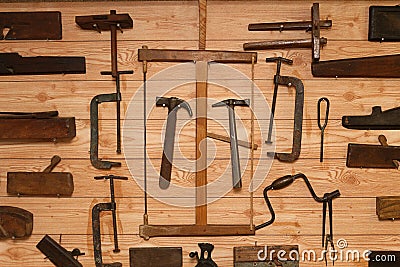 Ancient Carpenter Tools on a wooden wall Stock Photo