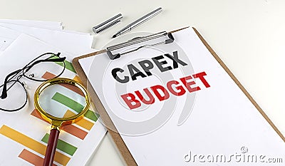 CAPEX BUDGET text on clipboard with chart on white background, business concept Stock Photo