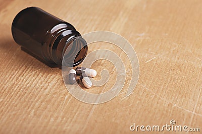Caplets or pills in front of the opening medicine bottle Stock Photo