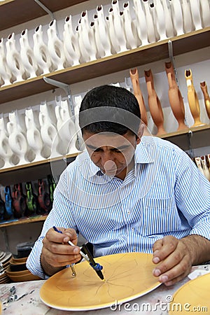 Ceramic artist drawing on traditional Turkish jug Editorial Stock Photo