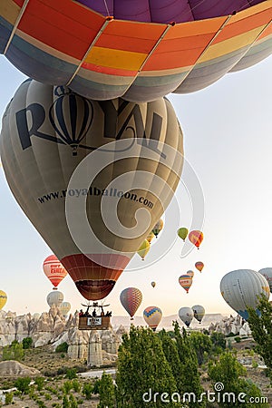 Cappadocia, Turkey - September 14, 2021: Wide angle view of bunch of colorful hot air balloons taking flight or flying int he sky Editorial Stock Photo