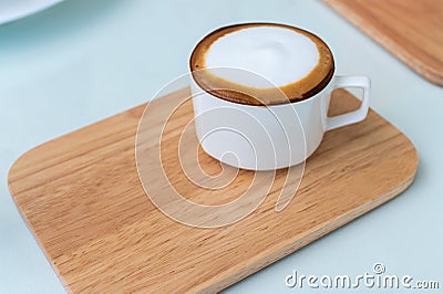 Cappuccino coffee cup on wooden plate Stock Photo