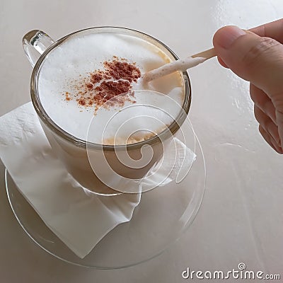 Cappuccino coffee in transparent glass cup Stock Photo
