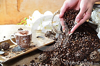 Cappuccino hand with falling beans Stock Photo
