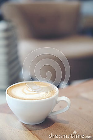 Cappuccino or Latte art coffee made from milk on wooden table in coffee shop Stock Photo