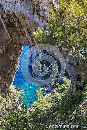 Capri Italy, island in a beautiful summer day, with faraglioni rocks and natural stone arch. Stock Photo