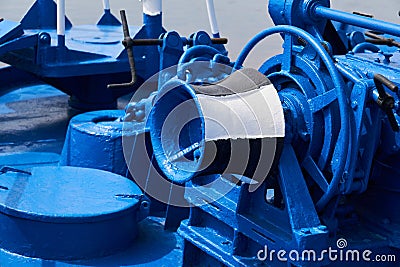 Capstan and other mechanisms, painted blue, on the foredeck of the ship, close-up Stock Photo