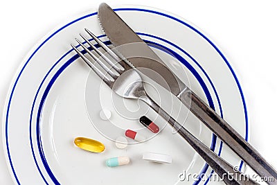 Overmedication -Capsules and hidden in a close-up plate with the broods. Stock Photo