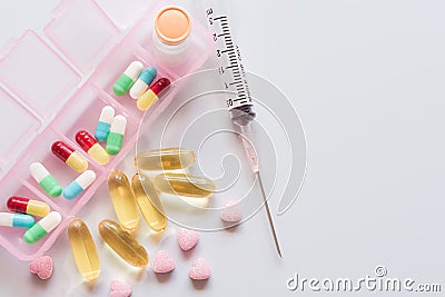 Capsules in a pill box, injectables, syringes ,fish oil and vita Stock Photo