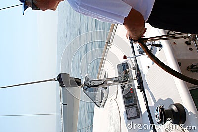 Captain beyond the yacht steering Stock Photo