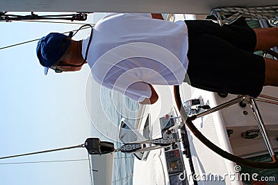 Captain beyond the yacht steering Stock Photo