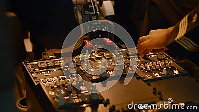 Captain and copilot pushing dashboard buttons to start engine Stock Photo
