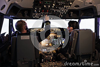 Captain and copilot using dashboard command to takeoff with plane Stock Photo