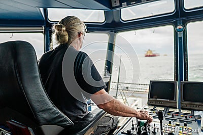 Captain of deck Officer on bridge of vessel or ship during navigaton watch at sea Stock Photo