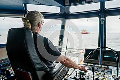 Captain of deck Officer on bridge of vessel or ship during navigaton watch at sea Stock Photo