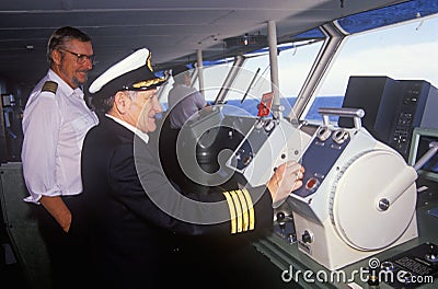 The captain of the ferry Bluenose piloting his boat as a navigator stands by, Yarmouth, Nova Scotia Editorial Stock Photo