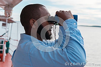 Captain holding binoculars in his hands Stock Photo