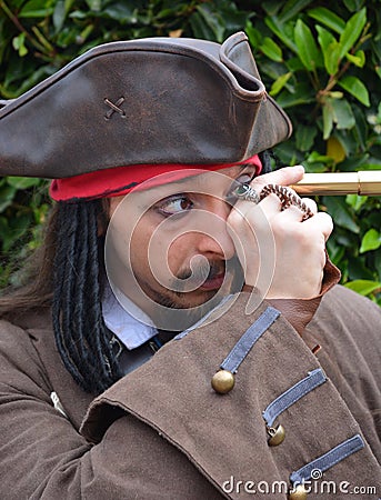 Captain Jack Sparrow. Cosplayer peers through telescope Editorial Stock Photo