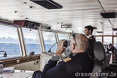Captain of cruiser glassing out for icebergs on Arctic Ocean Editorial Stock Photo