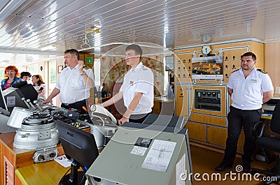Captain of river cruise ship Alexander Benois and captain`s assistants in captain`s cabin Editorial Stock Photo