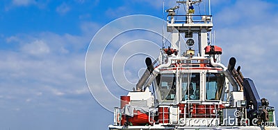 Captain`s bridge on the ship. Tug is at the pier in the sea port Stock Photo