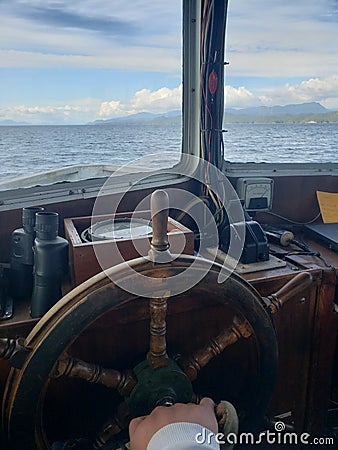 Captain wheel steering ocean scenic Stock Photo