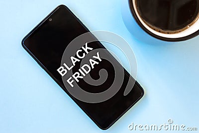 Caption BLACK FRIDAY on smartphone screen. Concept of sales, online shopping, and e-commerce. Stock Photo