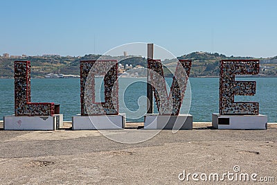 Caption Word Love: Metallic Structrure with Hanged little Hearts Stock Photo