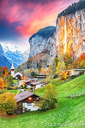 Captivating autumn view of Lauterbrunnen valley with gorgeous Staubbach waterfall and Swiss Alps at sunset time Stock Photo