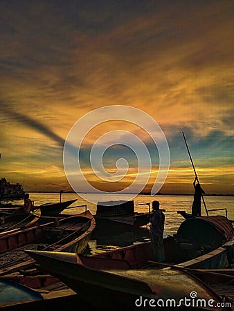 The Serenity of a Sunset Sky River with Boats Stock Photo