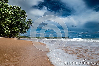 Captivating deserted beachscape with a radiant sun in a clear sky in Ghana, Africa Stock Photo