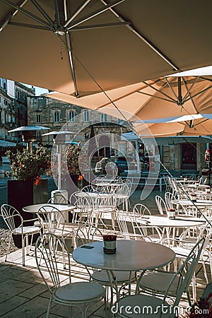 Ostuni's Historic Center Beautiful Piazza with Parasols Against Clear Blue Sky Editorial Stock Photo