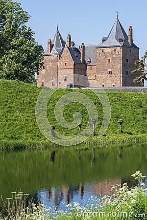Captivating view across the moat water over the dike to Slot Loevestein Castle and its rich history. The fortress is the most Stock Photo
