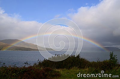 Captivating view of a full rainbow in the waters in Scotland Stock Photo
