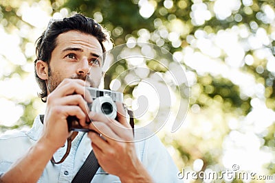 Capture that moment. a handsome young tourist checking out the sights. Stock Photo