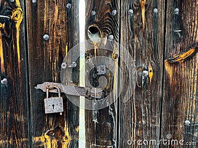 Capturing the nostalgia of an old wooden woor with an aged lock Stock Photo