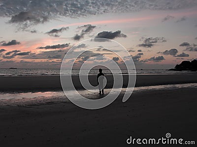 Capturing the Silhouette of a Man on the Beach when sunset Stock Photo