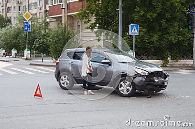 Car accident. The girl costs at the broken car at the intersection of roads. Tyumen, Russia. Editorial Stock Photo